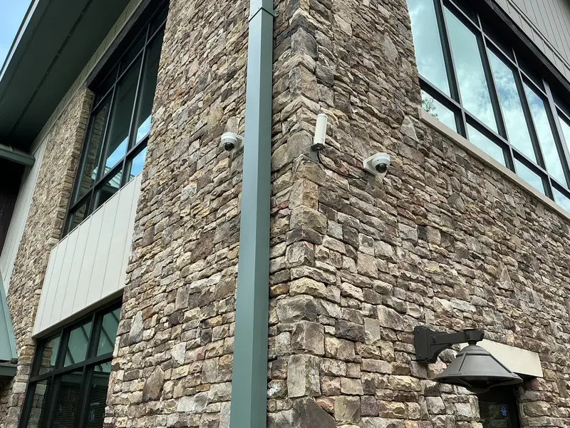 Security cameras installed on a stone commercial building